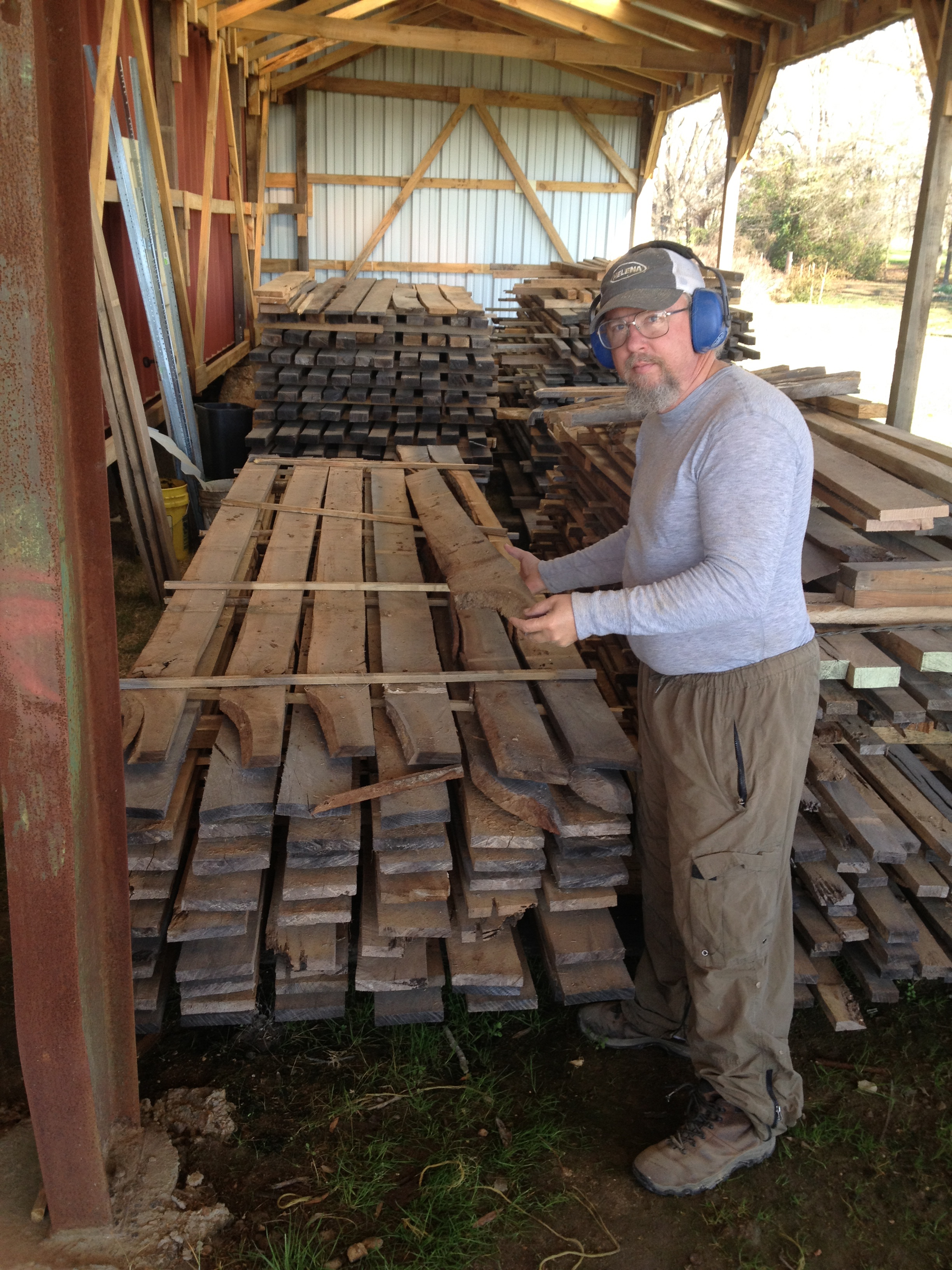 Kendall shows oak lumber stored in the drying shed.